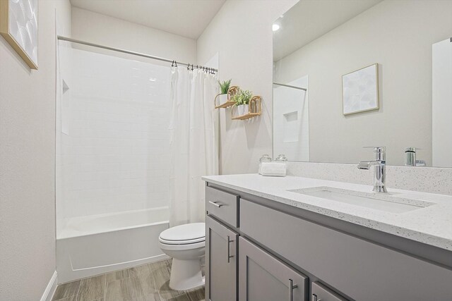 full bath featuring shower / bathtub combination with curtain, toilet, wood finished floors, and vanity