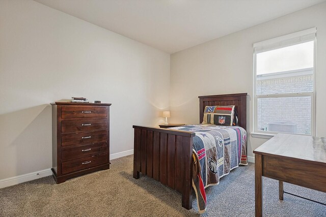 carpeted bedroom featuring baseboards