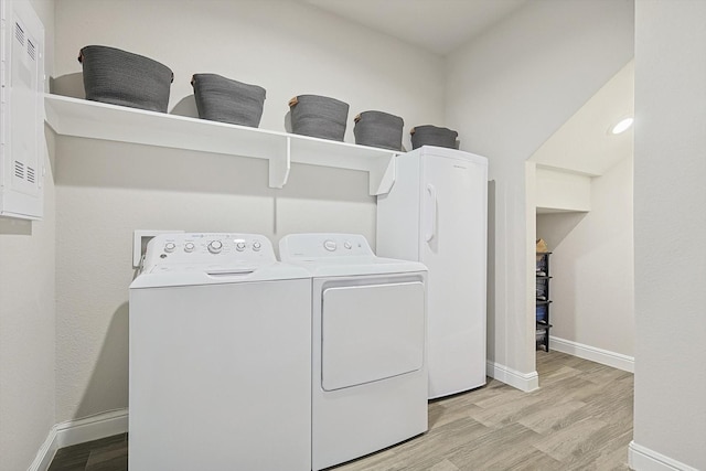 washroom featuring washer and clothes dryer and light hardwood / wood-style floors