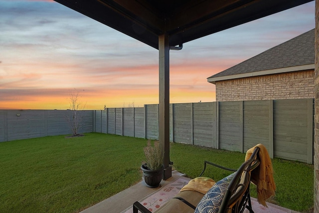 yard at dusk with a fenced backyard