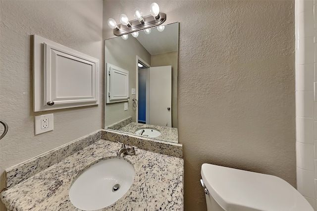 bathroom with toilet and vanity