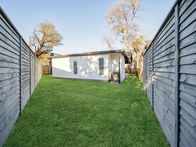 rear view of property with a lawn