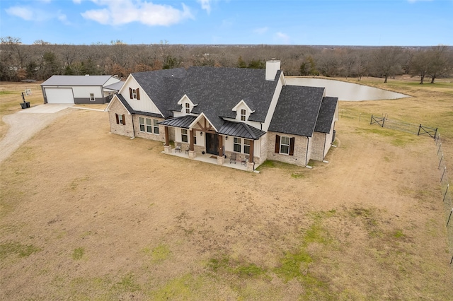 view of front of home featuring a garage, covered porch, and a front lawn