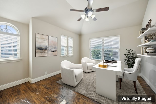 living area featuring dark wood-type flooring, lofted ceiling, plenty of natural light, and baseboards