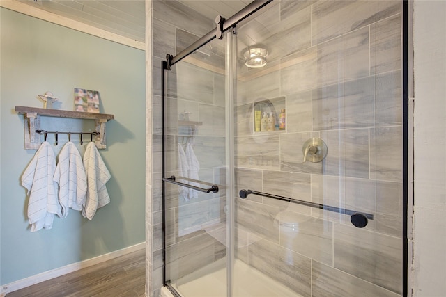 bathroom featuring hardwood / wood-style floors and a shower with door