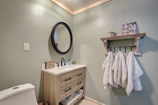 bathroom featuring toilet and vanity