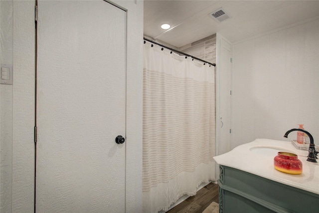 bathroom featuring vanity, hardwood / wood-style flooring, and a shower with curtain