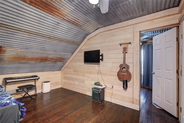 bedroom featuring dark wood-type flooring, wooden walls, vaulted ceiling, and wood ceiling