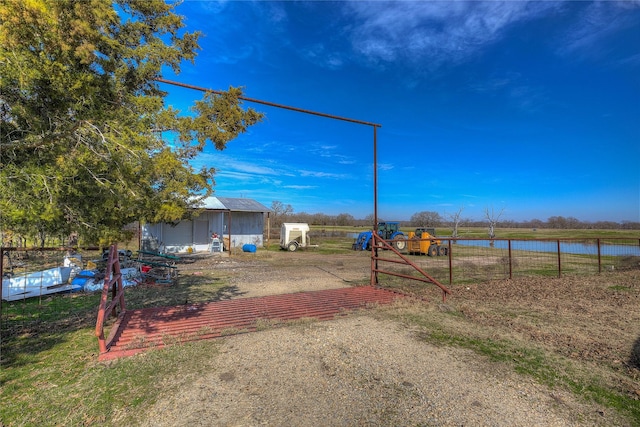 view of yard with a water view and a shed