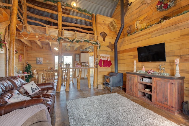 living room featuring wood walls, high vaulted ceiling, a wood stove, and wood ceiling