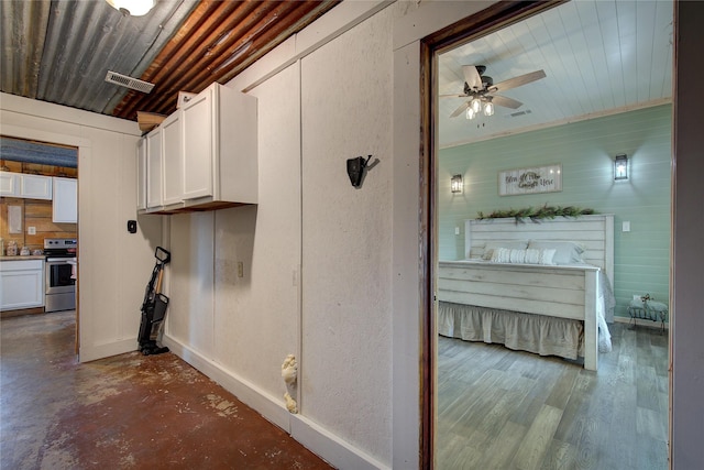 laundry area featuring ceiling fan and dark hardwood / wood-style floors