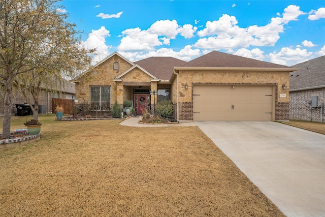 view of front of home featuring a front yard and a garage