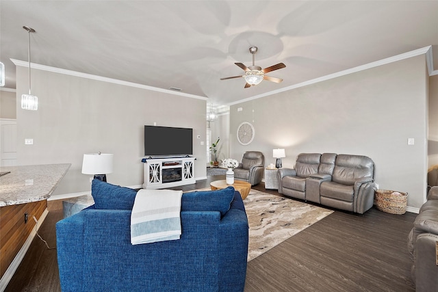 living room featuring ceiling fan, dark wood-type flooring, and ornamental molding