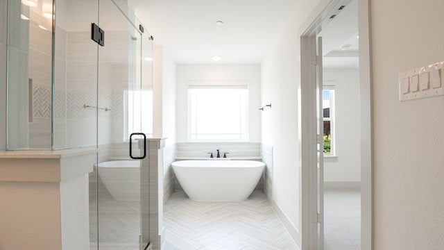 1804 Wittington Pl, Farmers Branch, TX 75234 - bathroom featuring a stall shower, a freestanding tub, and baseboards