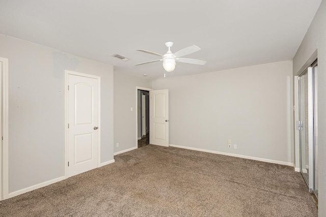 unfurnished bedroom with carpet, visible vents, baseboards, and ceiling fan