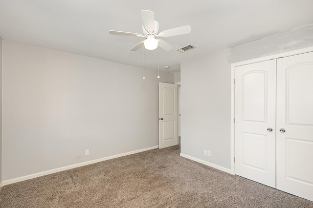 unfurnished bedroom with carpet, a closet, visible vents, a ceiling fan, and baseboards