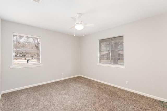 unfurnished room featuring ceiling fan, carpet floors, and baseboards