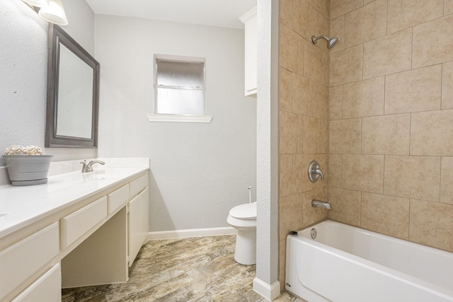 bathroom featuring double vanity, shower / bathtub combination, toilet, a sink, and baseboards