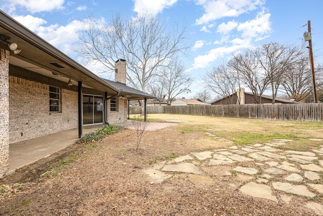 view of yard with a fenced backyard and a patio