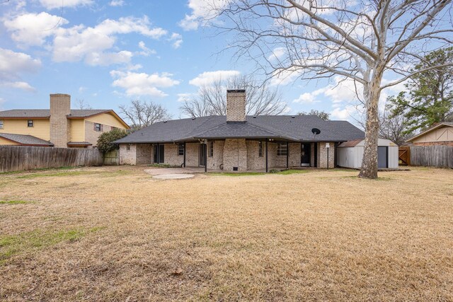 rear view of property with a storage shed, a fenced backyard, a patio area, and an outbuilding