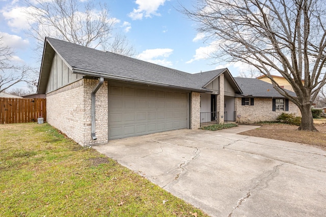 view of front of house with an attached garage, fence, concrete driveway, and roof with shingles