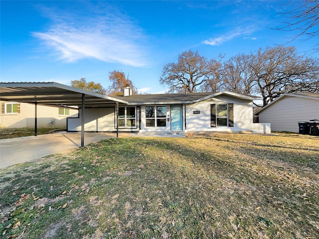 ranch-style home with a front lawn and a carport