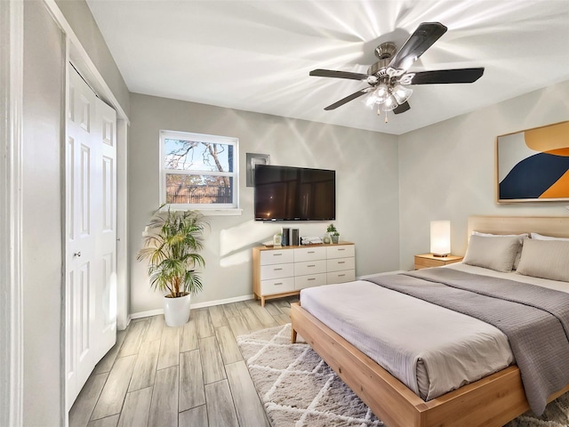 bedroom featuring light hardwood / wood-style flooring, a closet, and ceiling fan