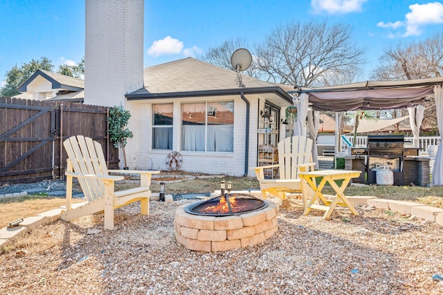 back of house featuring an outdoor fire pit