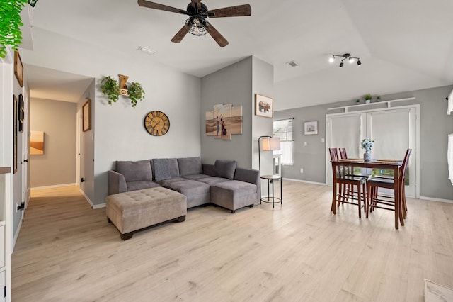 living room featuring ceiling fan, light hardwood / wood-style floors, and lofted ceiling