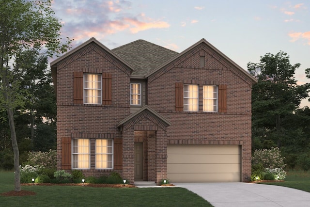 view of front facade featuring a garage and a yard