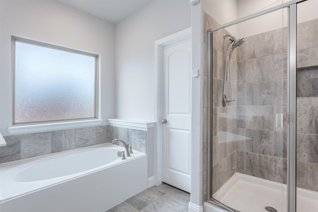 bathroom with tile patterned floors and separate shower and tub