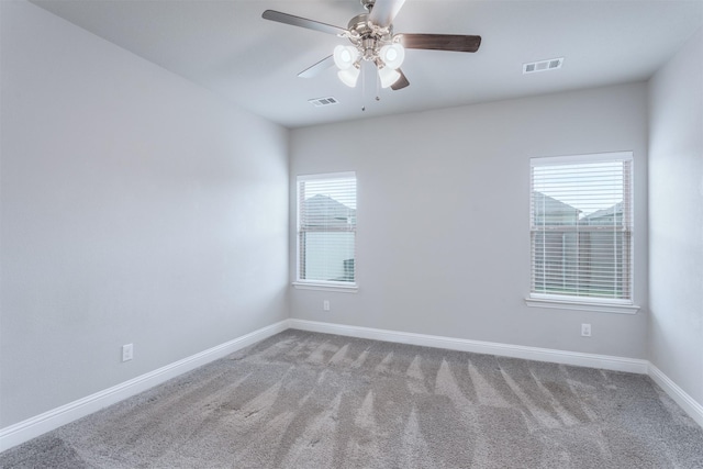 unfurnished room with ceiling fan and light carpet