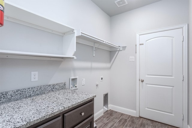 washroom featuring hookup for an electric dryer, cabinets, and washer hookup