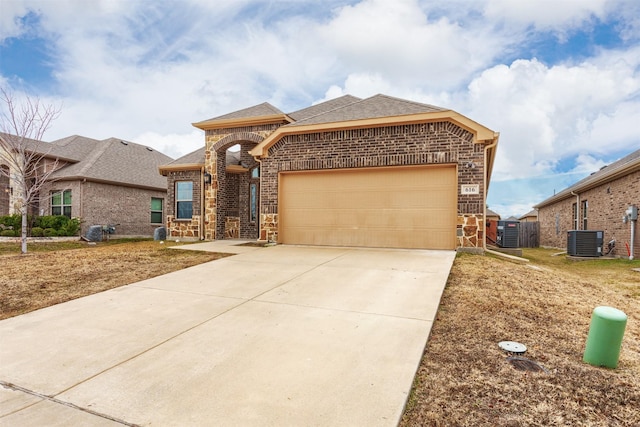 view of front facade featuring a garage and central AC