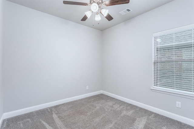 carpeted empty room featuring ceiling fan