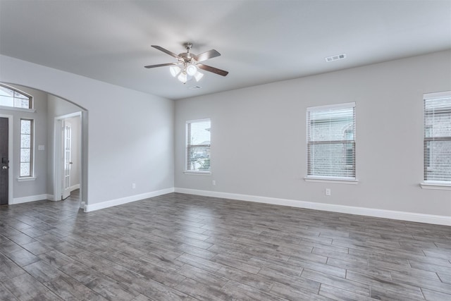 unfurnished room with ceiling fan and plenty of natural light