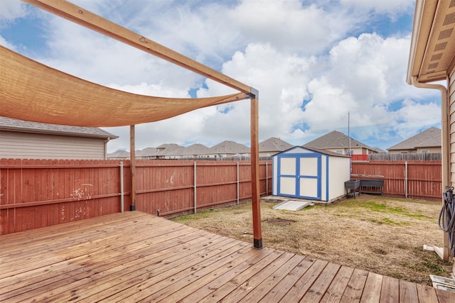 wooden deck featuring a shed and a yard