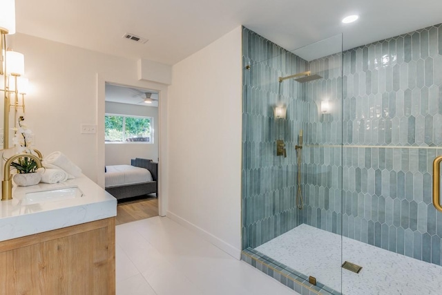 bathroom featuring vanity, tile patterned floors, and a shower with door