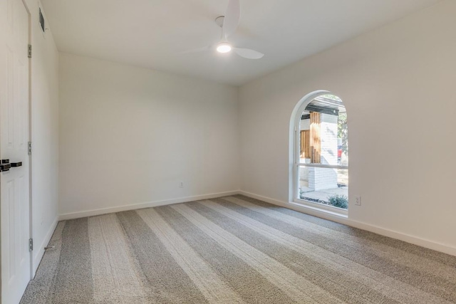 spare room featuring carpet flooring and ceiling fan