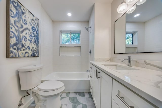 full bathroom featuring vanity, toilet, plenty of natural light, and tiled shower / bath combo