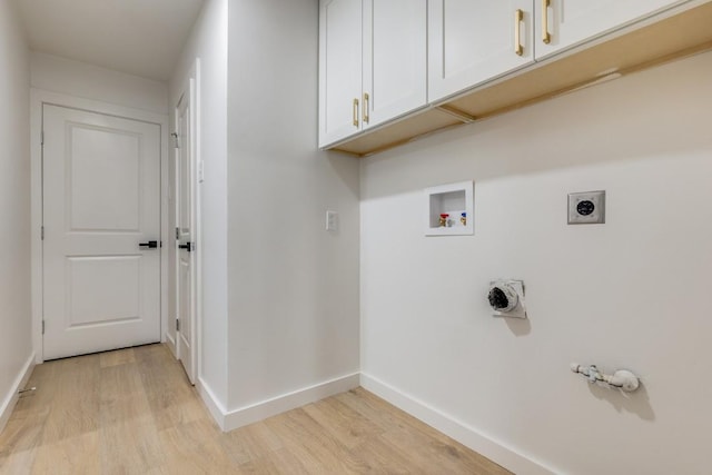 laundry area with washer hookup, light hardwood / wood-style flooring, hookup for an electric dryer, and cabinets