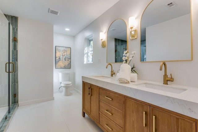 bathroom featuring vanity, toilet, and a shower with door