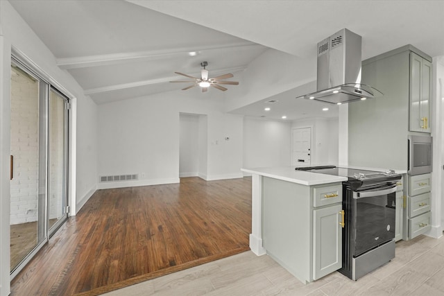 kitchen featuring ceiling fan, stainless steel electric range oven, light wood-type flooring, vaulted ceiling with beams, and island range hood