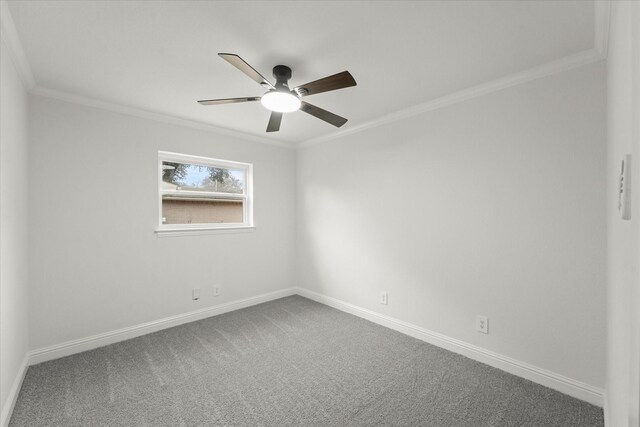 carpeted spare room featuring ceiling fan and ornamental molding