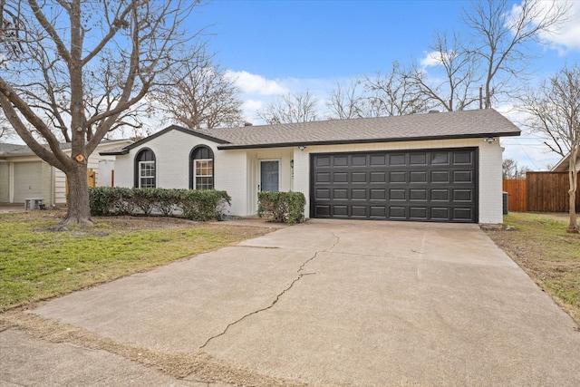 ranch-style home with a garage and a front yard