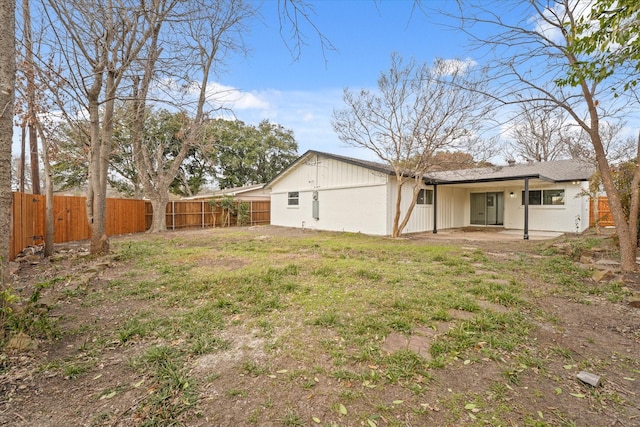 back of house with a patio and a yard