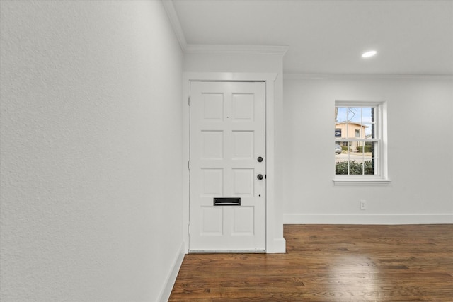 entrance foyer with dark hardwood / wood-style floors and ornamental molding