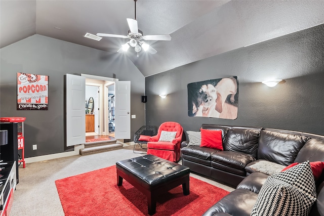 carpeted home theater featuring ceiling fan and lofted ceiling