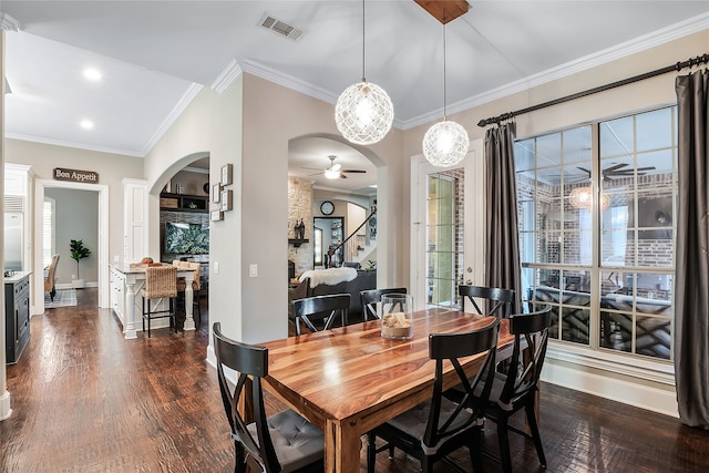 dining room with ceiling fan, ornamental molding, and dark hardwood / wood-style flooring