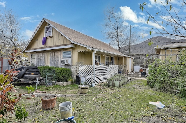 back of house with cooling unit and a yard